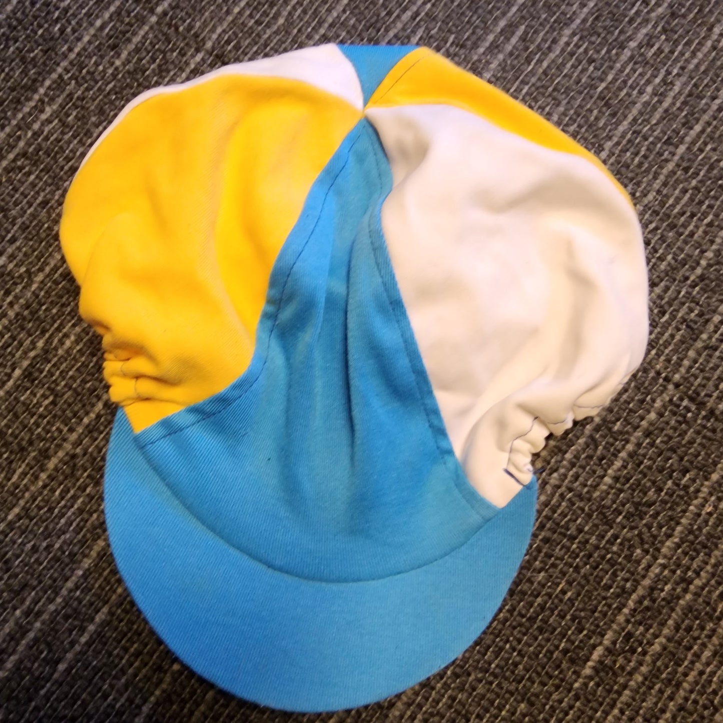 Blue, yellow and white helmet cover